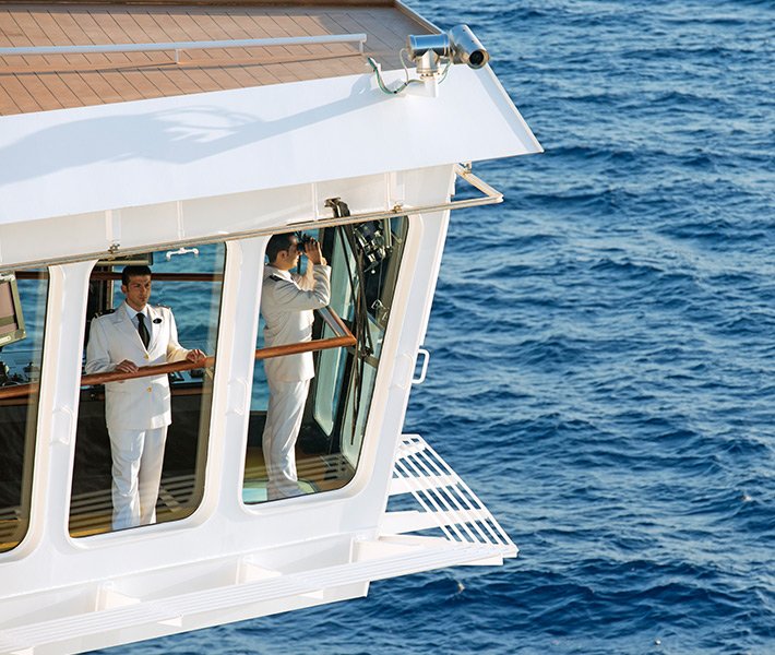 Ship officers in the bridge overlooking the ocean | MSC Cruises Ship officers in the bridge overlooking the ocean | MSC Cruises