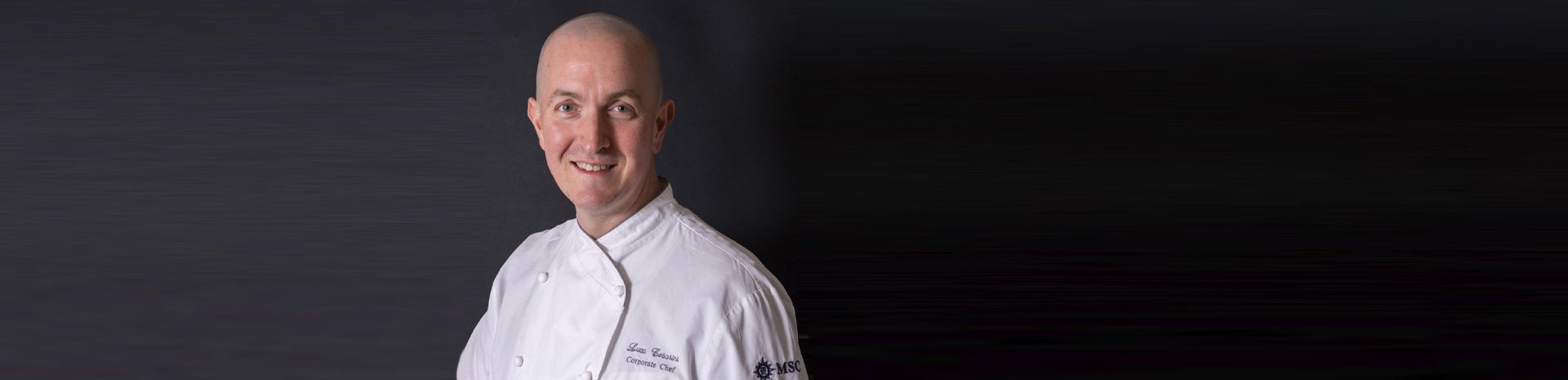 A chef in a white uniform showcasing MSC's culinary expertise | MSC Cruises A chef in a white uniform showcasing MSC's culinary expertise | MSC Cruises